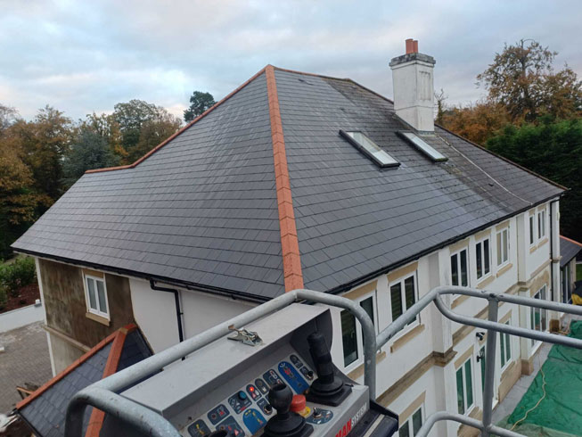 roof cleaning with a hot jet wash system (steam cleaning) midway through the clean